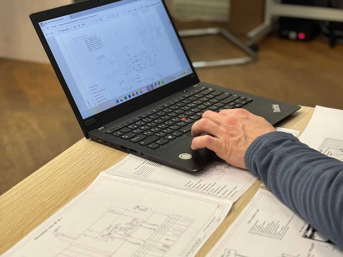 A quantity surveyor reviewing construction plans at a desk