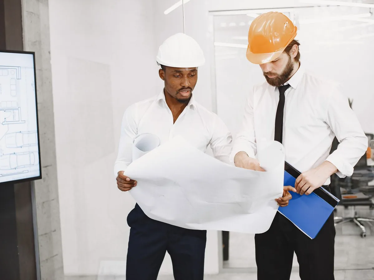 Construction professionals reviewing drawings together on site